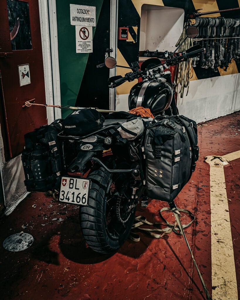 Motorcycle equipped with luggage and gear for long-distance travel.