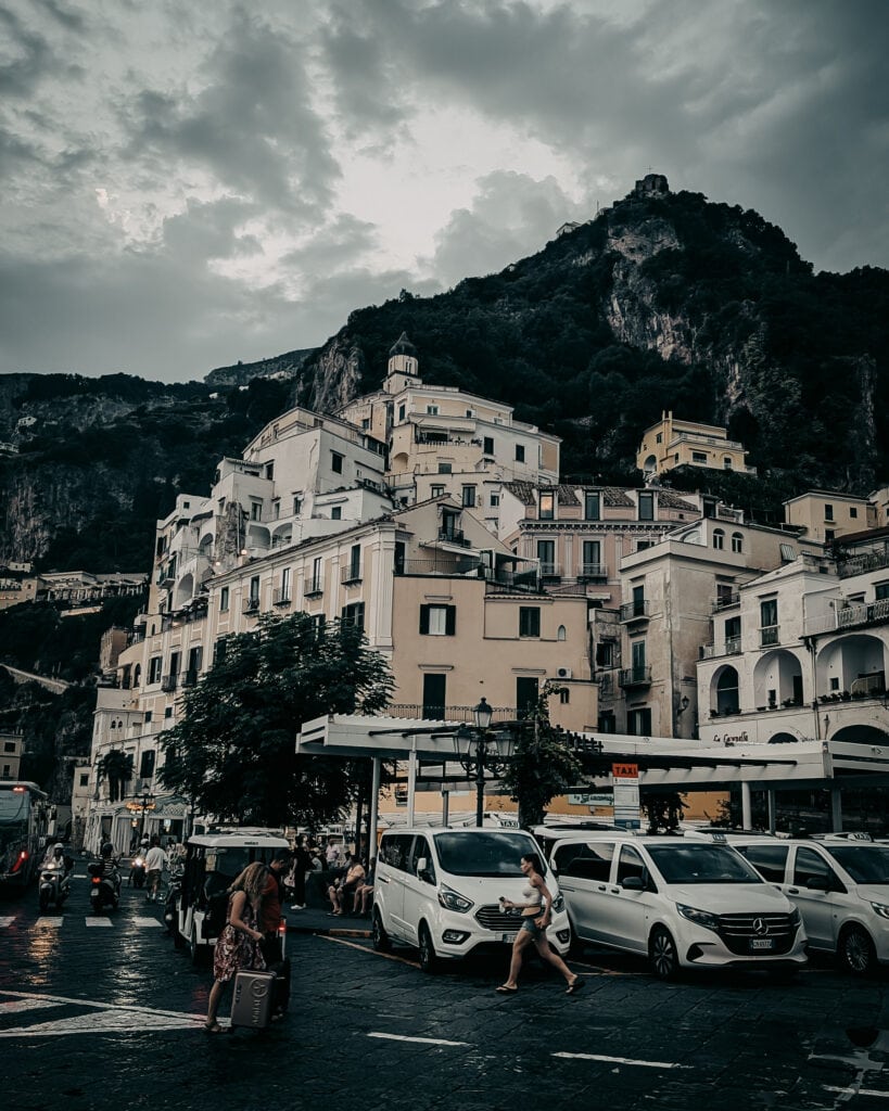 Charming coastal village with white buildings and mountain backdrop in Amalfi Coast.