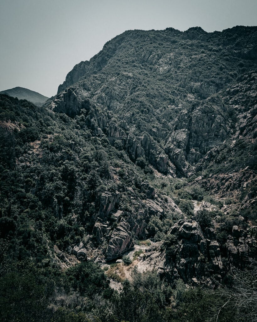 Majestic mountain landscape with rugged terrain and lush greenery.