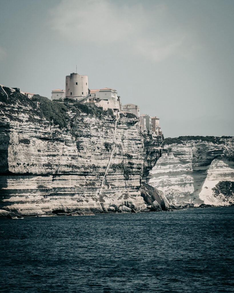 Scenic coastal cliffs with buildings overlooking the sea.