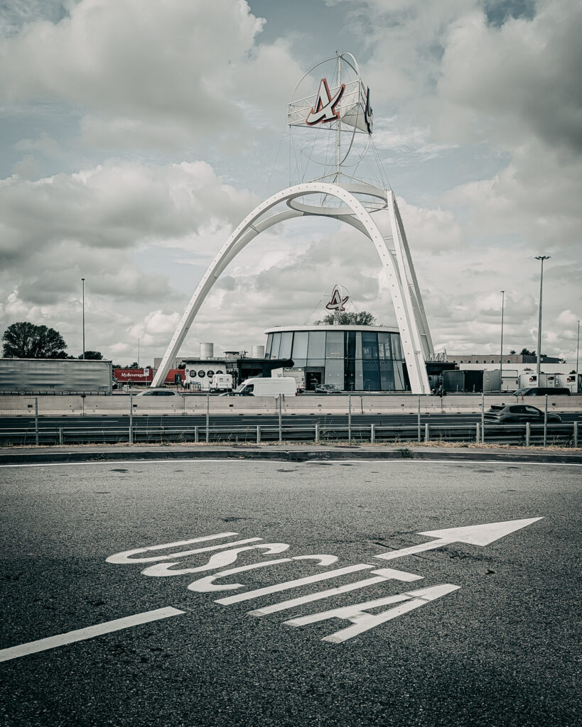 Iconic landmark with modern design and sailboat sculpture in the sky.